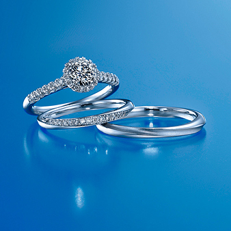 銀座ダイヤモンドシライシ：【ブーケ 】 中央と周りのダイヤは丸いブーケ、サイドに流れるダイヤはブーケを結ぶリボンを表現