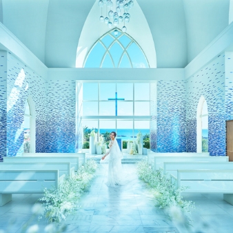 シギラ ミラージュチャペル／シギラセブンマイルズリゾート：◆グランドオープンフェア◆オンライン相談会スタート！：【今秋、人気チャペルがグランドリニューアル】宮古島屈指のリゾートに浸る滞在型Wを水平線まで見渡す海の眺めがどこまでも広がるチャペル。天井に煌く瑞々しい珊瑚色のオブジェやステンドグラスの透明感と相まって、まるで海の中に居るかのよう。ふたりの式を通して、ゲストに〈宮古島の海〉を五感で体感してもらえる。